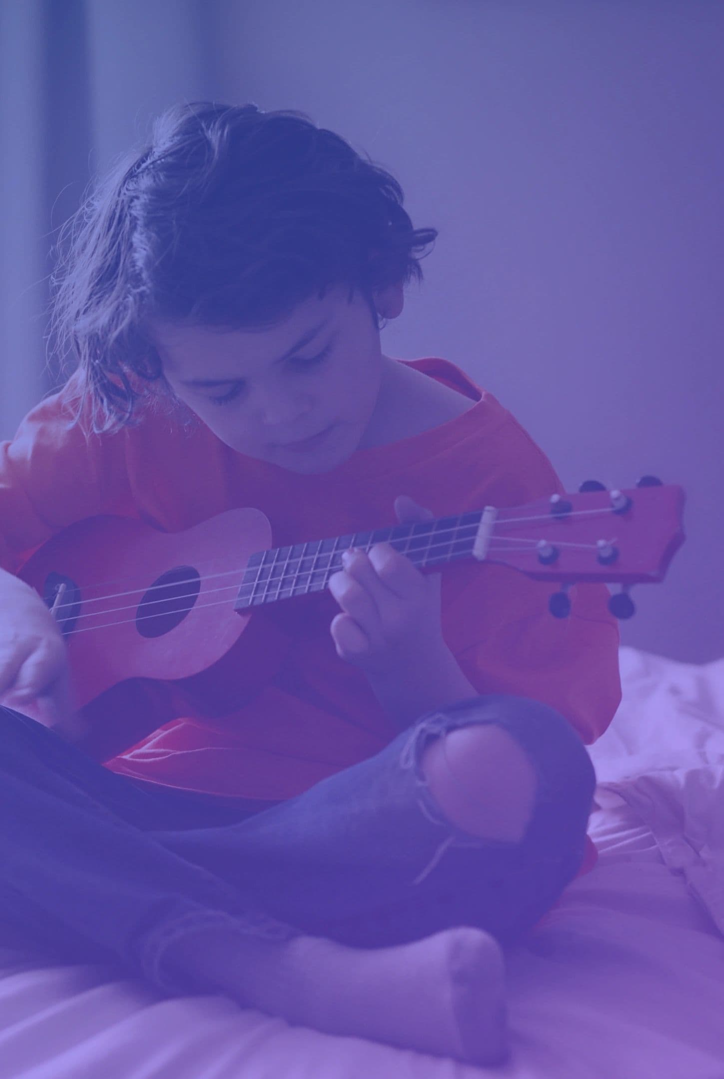 Young musician playing ukulele